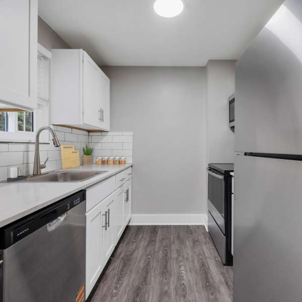 Modern kitchen with stainless steel appliances at Valley Brook Townhomes in Rochester, New York