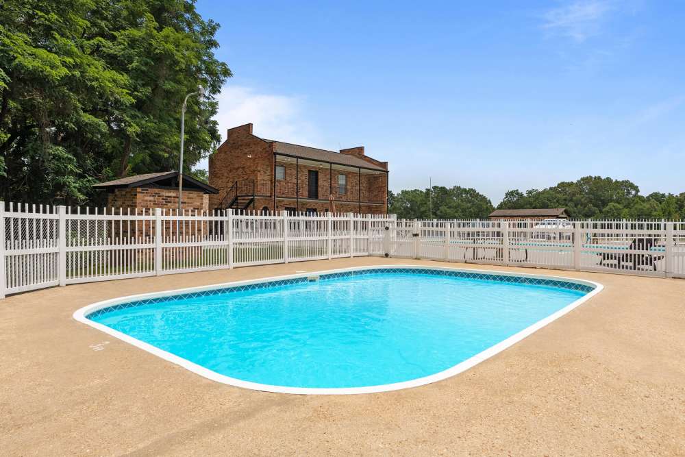 Charming property featuring a sparkling water pool and lush landscaping at Pecan Ridge in Vicksburg, Mississippi.