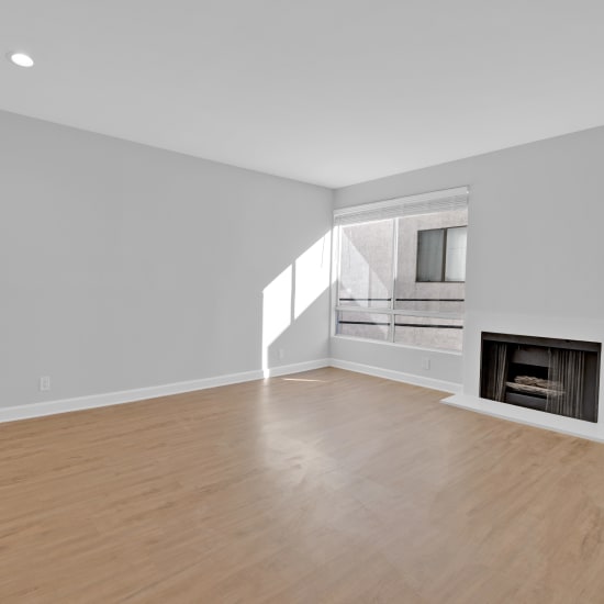 Spacious apartment with wood-style flooring and a fireplace at The Tower at Hollywood Hills in Los Angeles, California