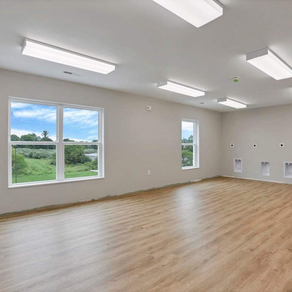 Light wood flooring with large windows at The Lofts On First in The Plains, Ohio