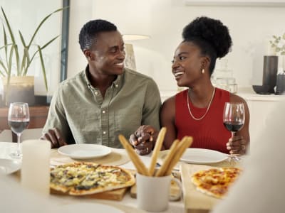 A couple enjoys dinner in their new apartment at Courtyard in Hayward, California