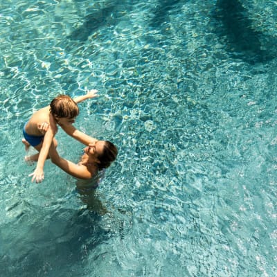 Residents take a swim in the pool at Anatole at the Pines in Conroe, Texas