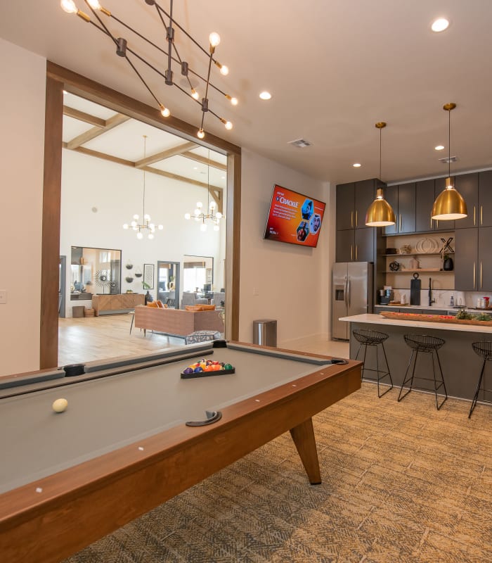 Spacious clubhouse with bar seating and billiards at Artisan Crossing in Norman, Oklahoma