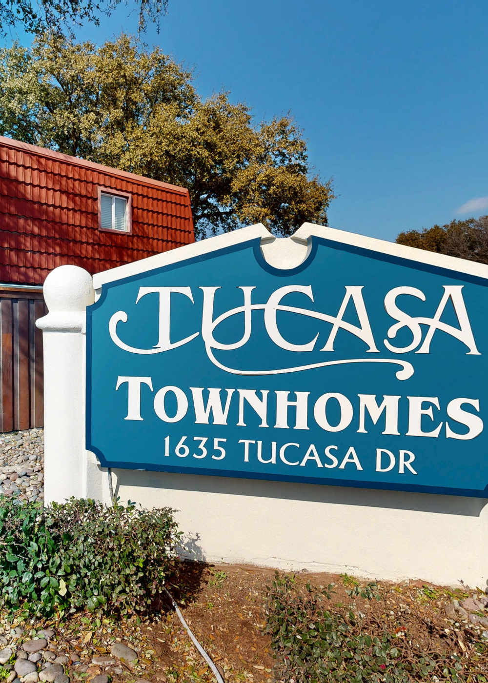 Property signage board at Tucasa Townhomes in Irving, Texas