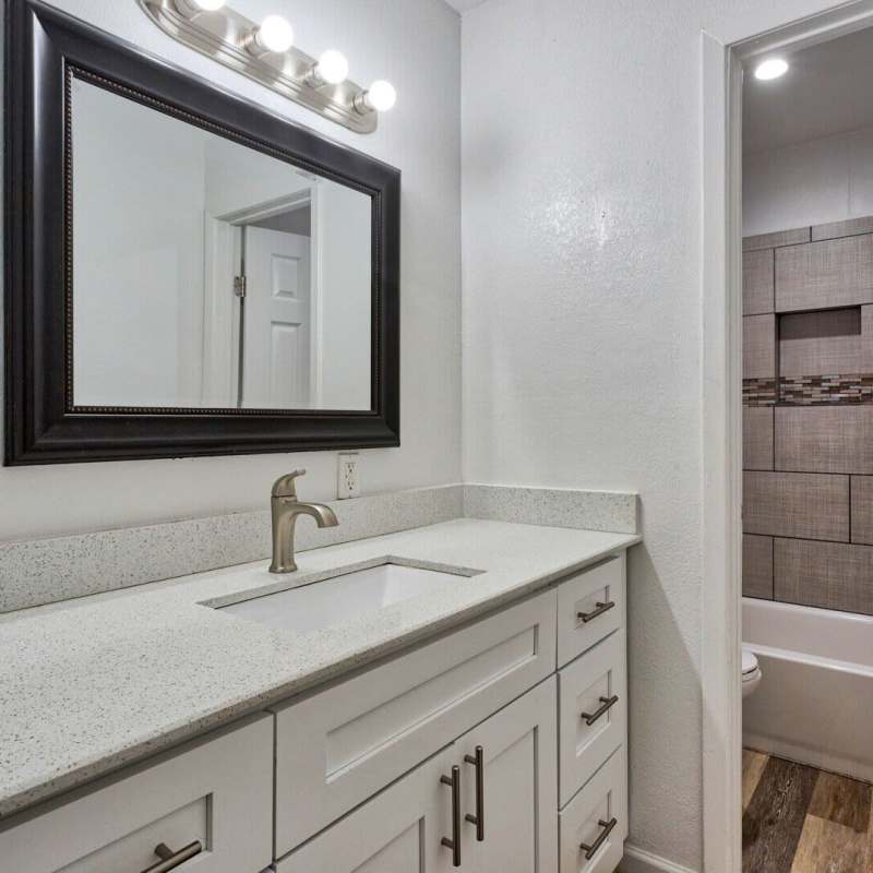 Bathroom with mirror and storage space at The Edge Of Moore in Moore, Oklahoma