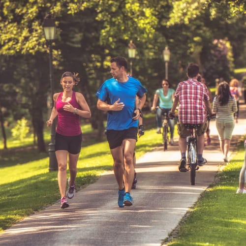 Residents jogging in a park near Accent Suwanee Creek in Duluth, Georgia