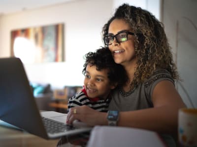 Mother and child looking at a computer at City Walk Apartments in Concord, California