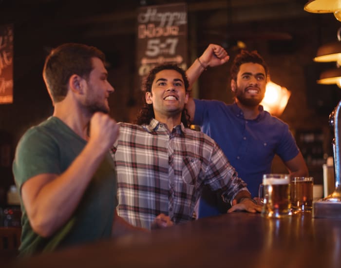 Friends drinking beer at a bar near Skyline Terrace