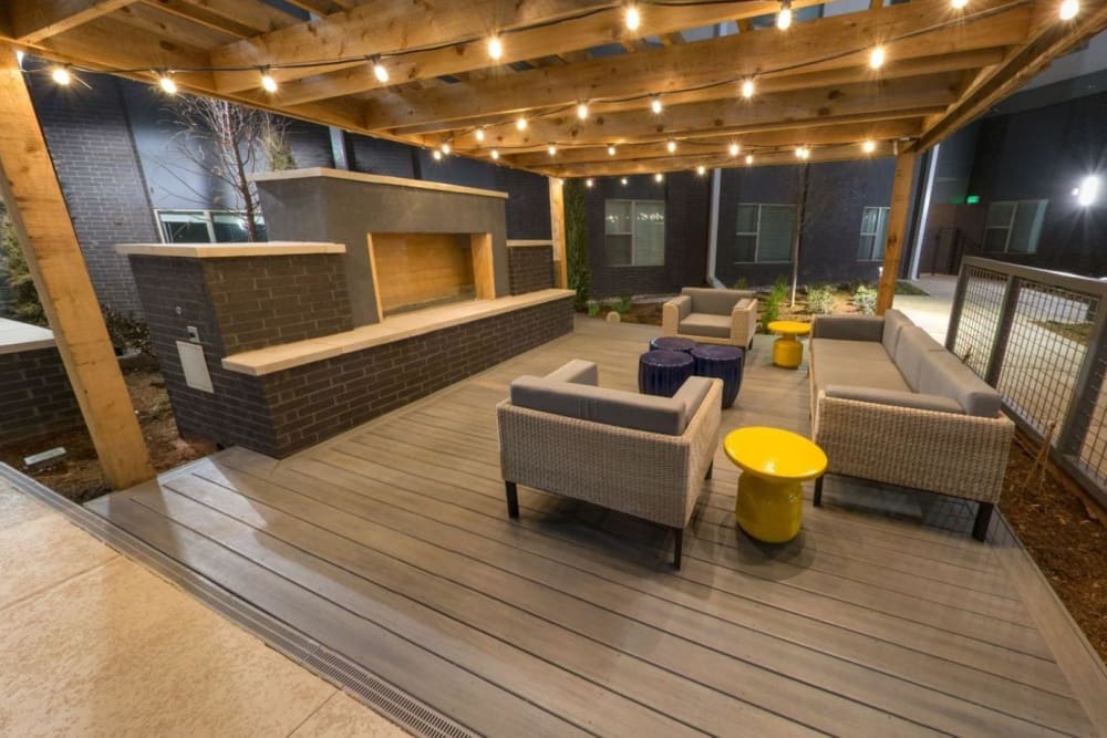 Outdoor lounge space with twinkle lights and a fireplace at Argon in Oklahoma City, Oklahoma