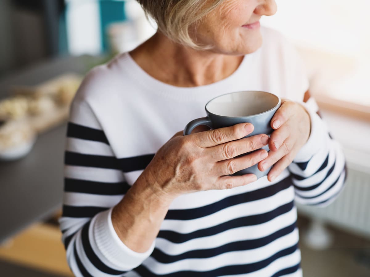 resident drinking coffee  at Brightwater Senior Living of Tuxedo in Winnipeg, Manitoba