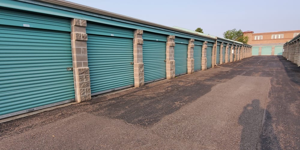 Outdoor storage units with green doors at StorQuest Self Storage in Parker, Colorado