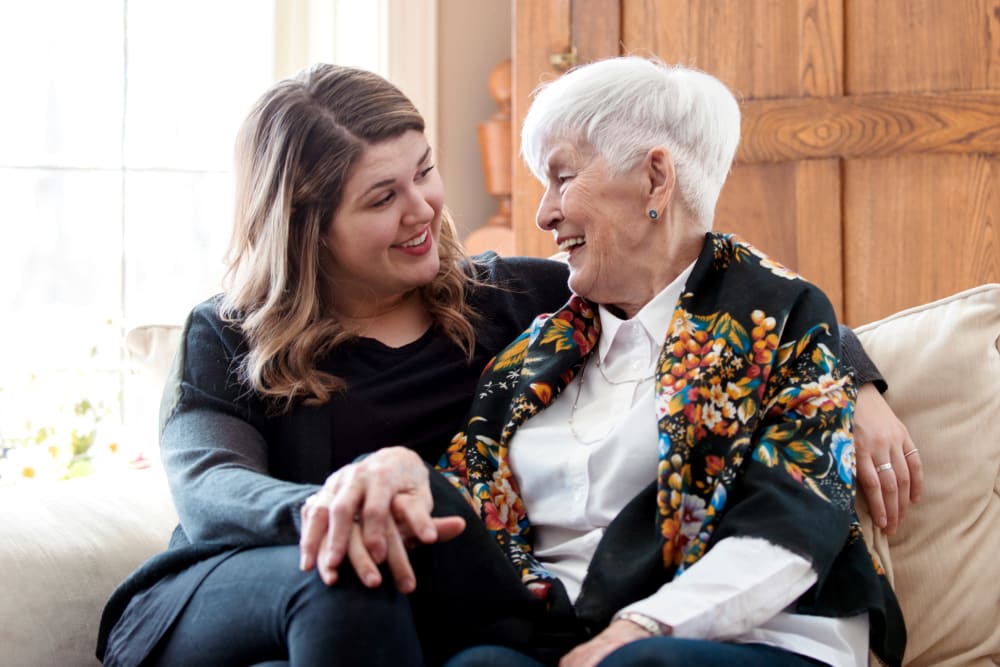 Resident and her daughter on the couch talking at Meridian Senior Living in Bethesda, Maryland