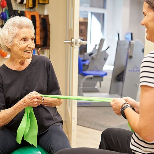 Resident working out with fitness instructor at Bartlett Reserve in Durham, North Carolina