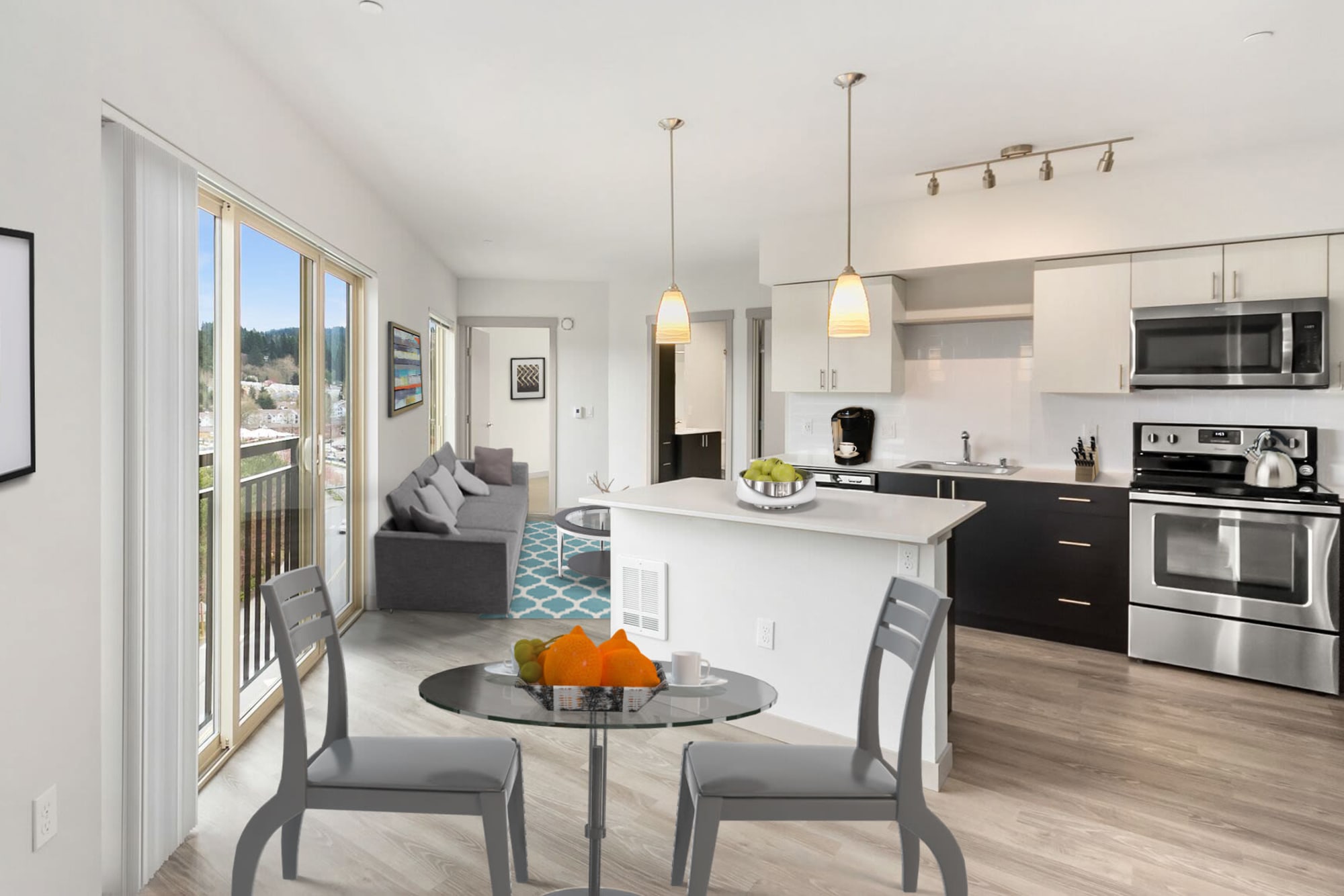Huge windows provide extra sunlight for this this large living space at Tria Apartments