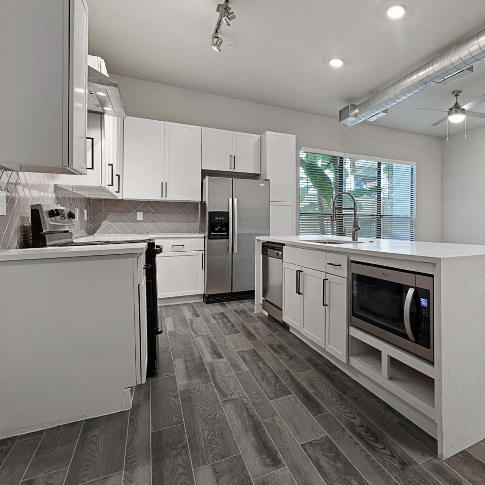 Fully equipped kitchen with stainless steel appliances at Briar Forest Lofts in Houston, Texas