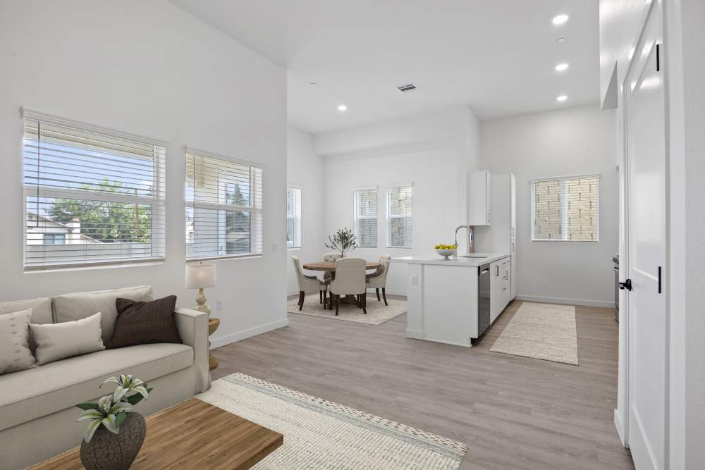 Kitchen decorated and dining area with modern furniture and finishes at Canyon Bluffs Apartment Homes in Riverside, 