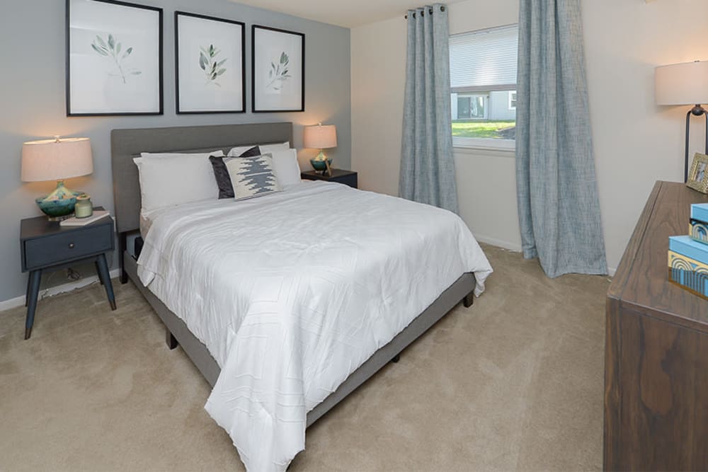 Model bedroom with plush carpeting at The Landings Apartment Homes in Absecon, New Jersey