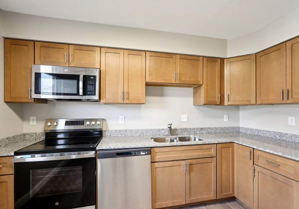 Kitchen with wood cabinets at Charleston Square Apartments in Columbus, Indiana