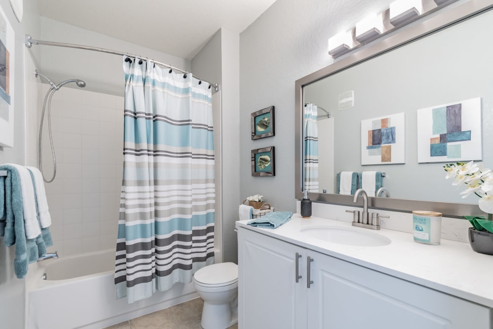 Apartment bathroom with granite counter tops at The Parq at Cross Creek in Tampa, Florida