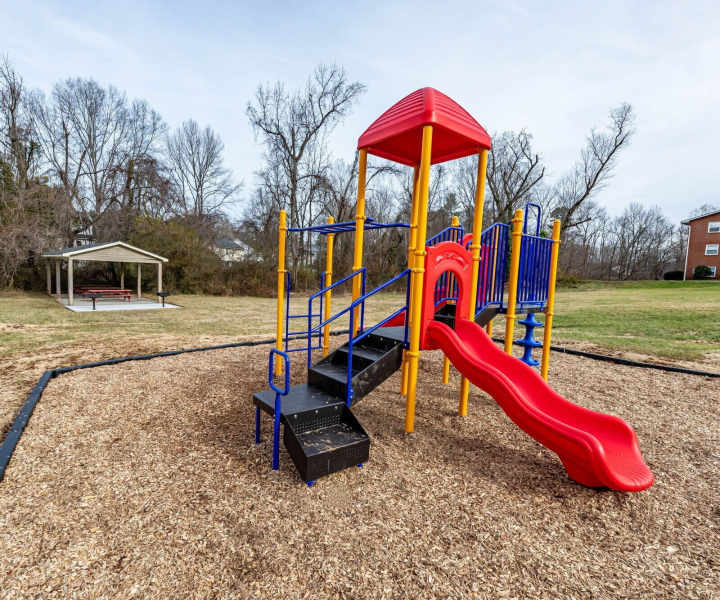 Kids playground with green lawn at Lofts At Glenhaven in Winston Salem, North Carolina