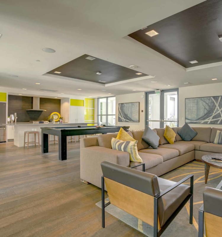Resident clubhouse with bar seating and a billiards table at Domus on the Boulevard in Mountain View, California