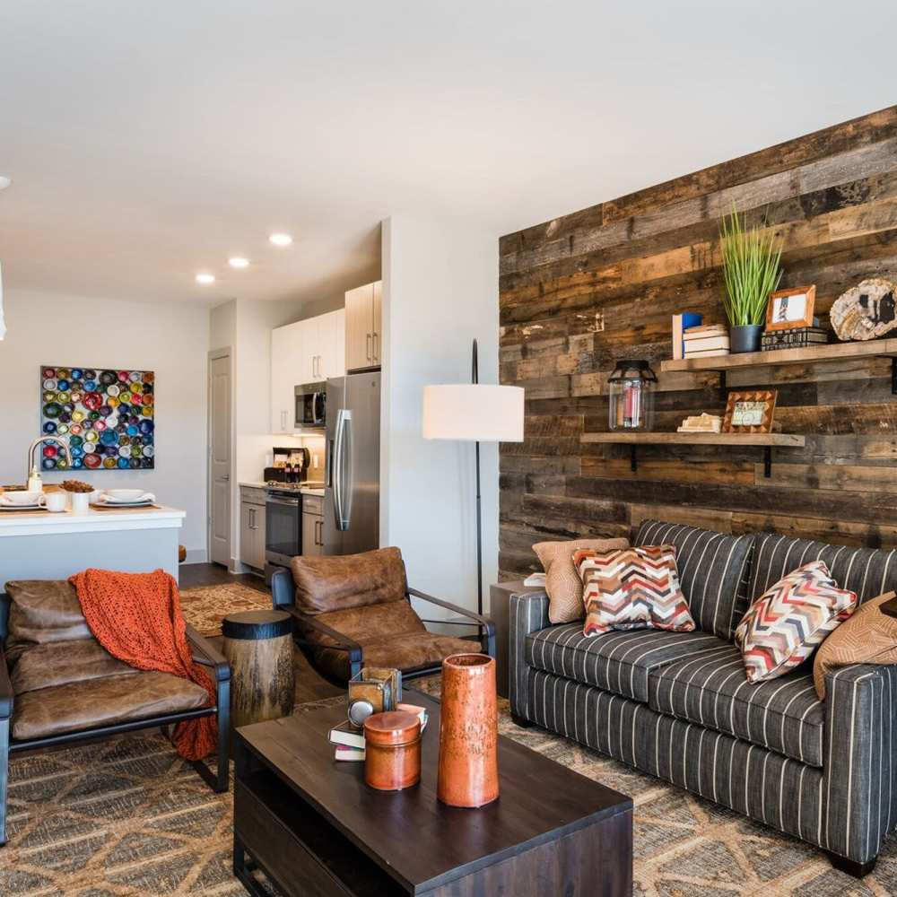 A cozy living room with wood paneling and a comfortable couch at Siena Suwanee Town Center in Suwanee, Georgia