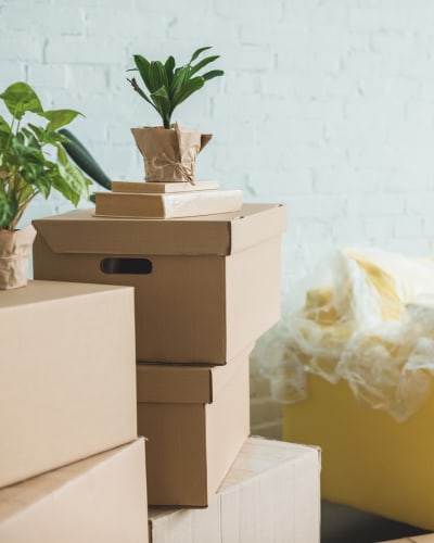 A stack of boxes in front of an open storage unit at A Storage Place 