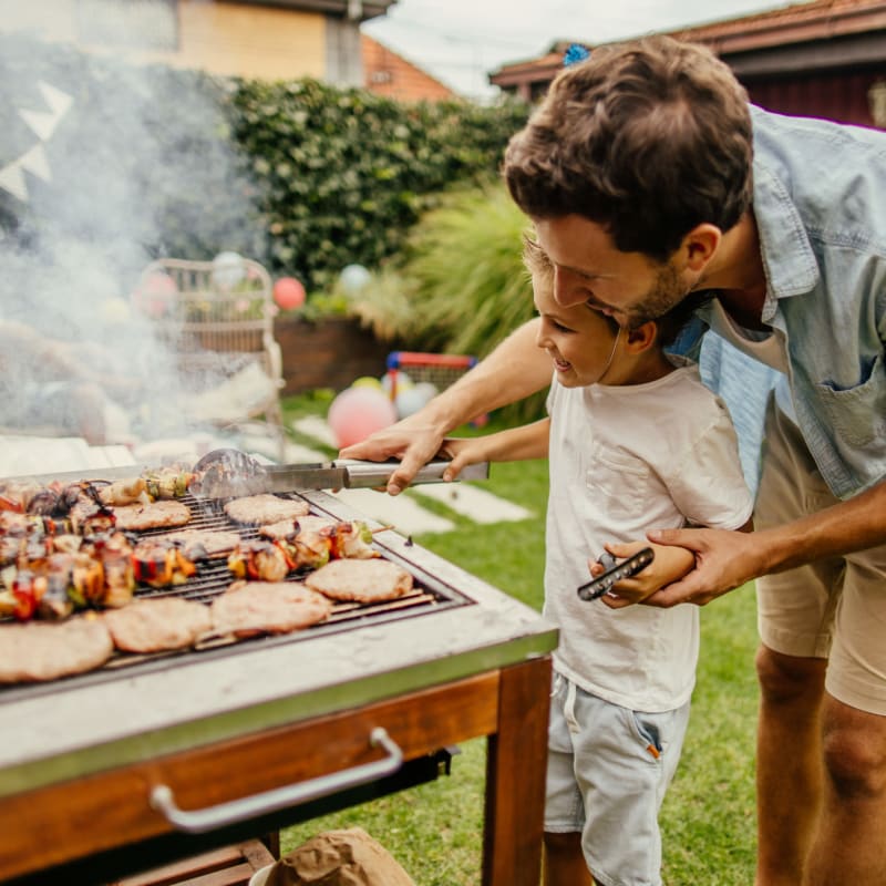 A father and son barbeque at The Amber at Greenbrier, Chesapeake, Virginia