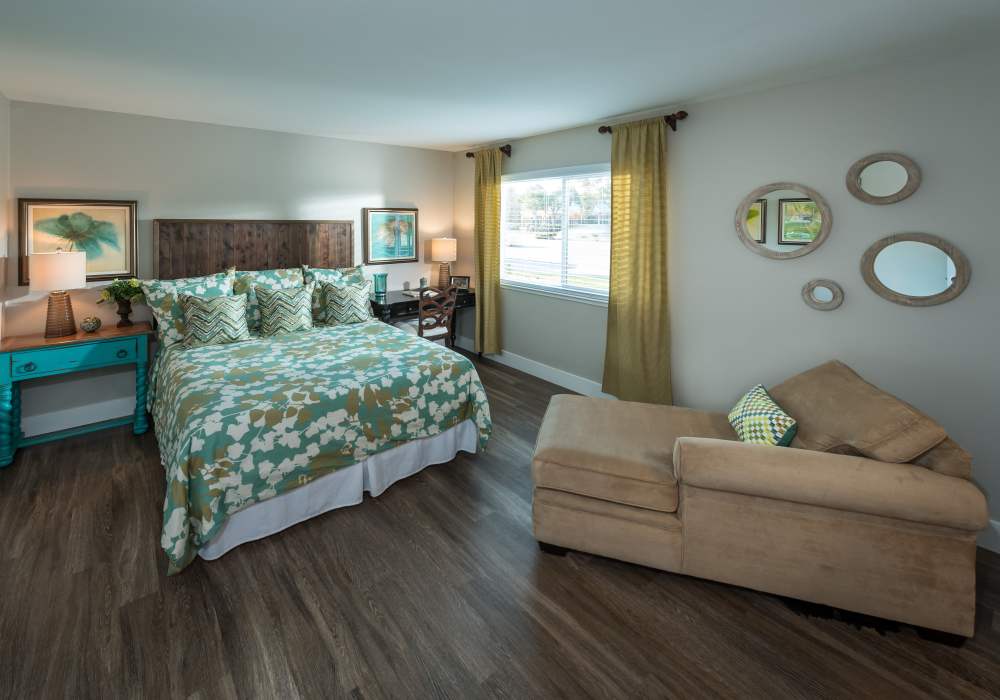 Bright bedroom with large windows at Harbor Cove Apartments in Foster City, California,
