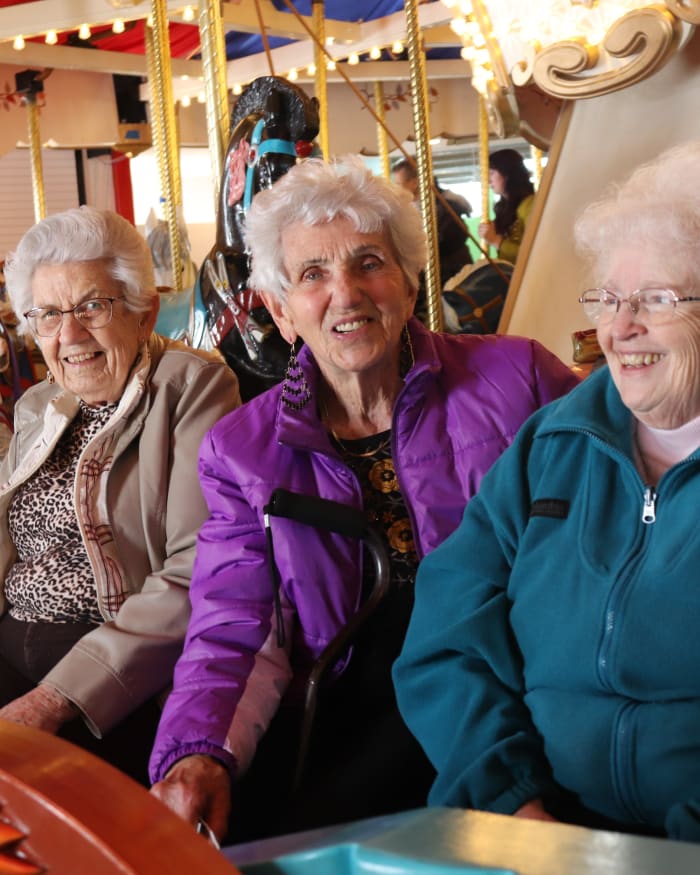 Residents connecting with other residents at a carousel at The Springs at Butte in Butte, Montana.