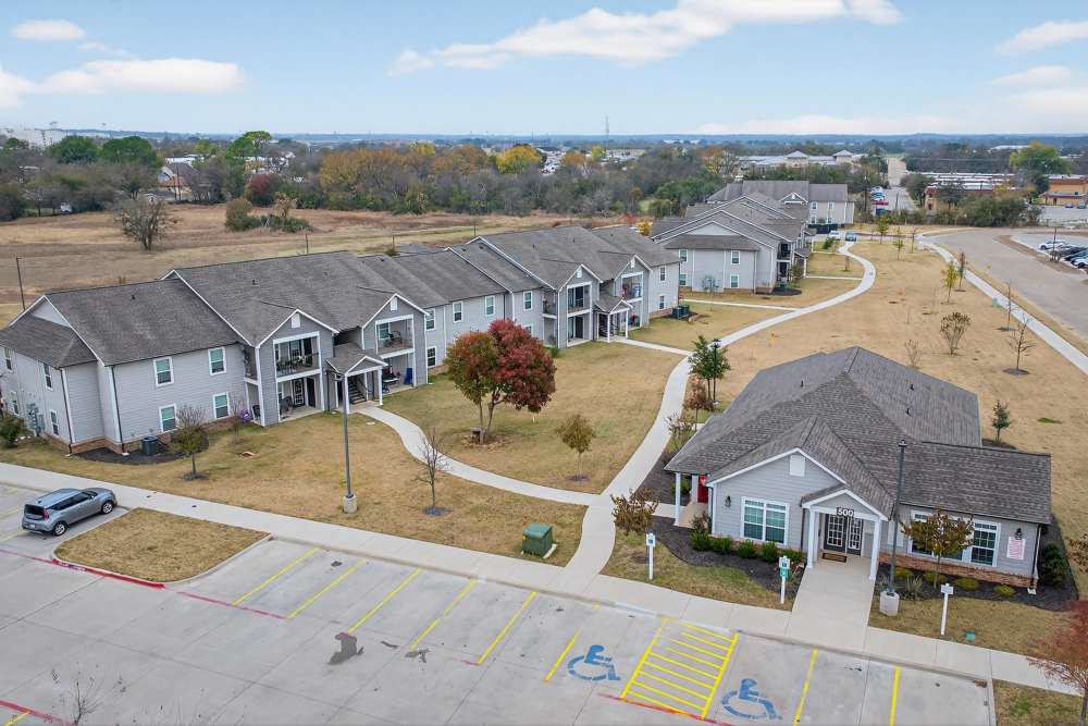 Charming community with modern architecture and lush landscaping at Lakewood Crossing in Granbury, Texas.