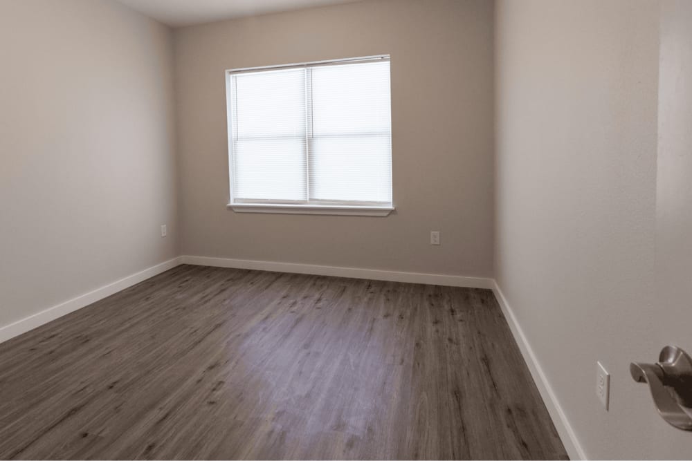 Bedroom with wood-style flooring at The Trail Lakes in Fort Worth, Texas