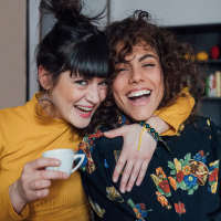 Two women drinking coffee at Sagamore Apartments in Benbrook, Texas