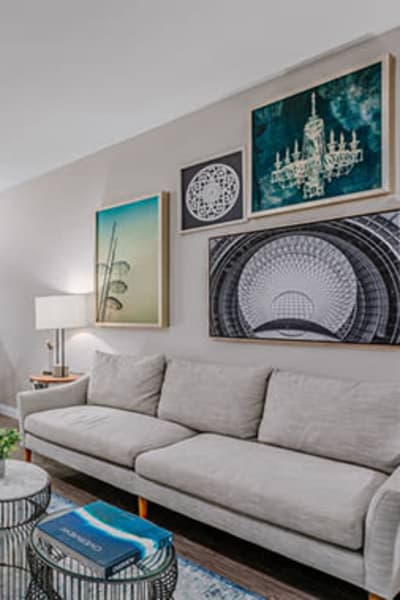 Model living space with a lot of wall-art at Reserve at South Coast in Santa Ana, California