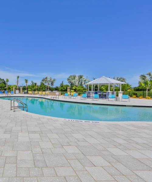 Resort-style pool with lounge chairs at Bayview Student Living in North Miami, Florida