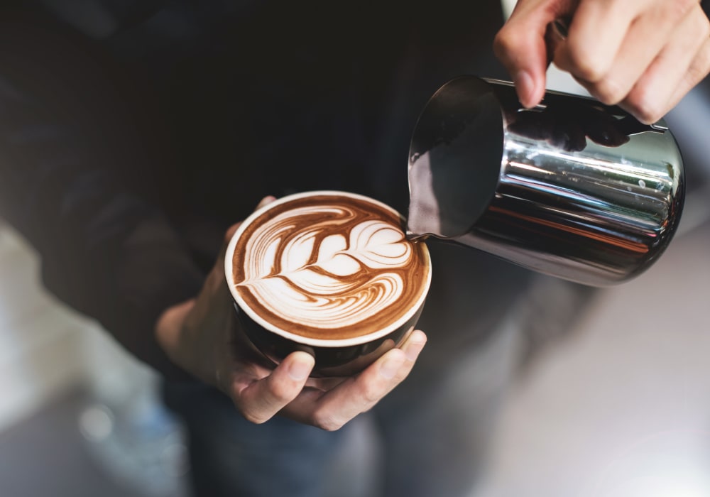 Barista making a latté for a customer near Sofi Belmont Glen in Belmont, California