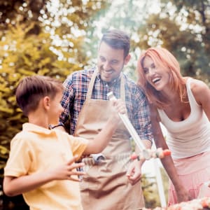 Family grilling out on a summer evening at The Majestic at Hewitt in Hewitt, Texas