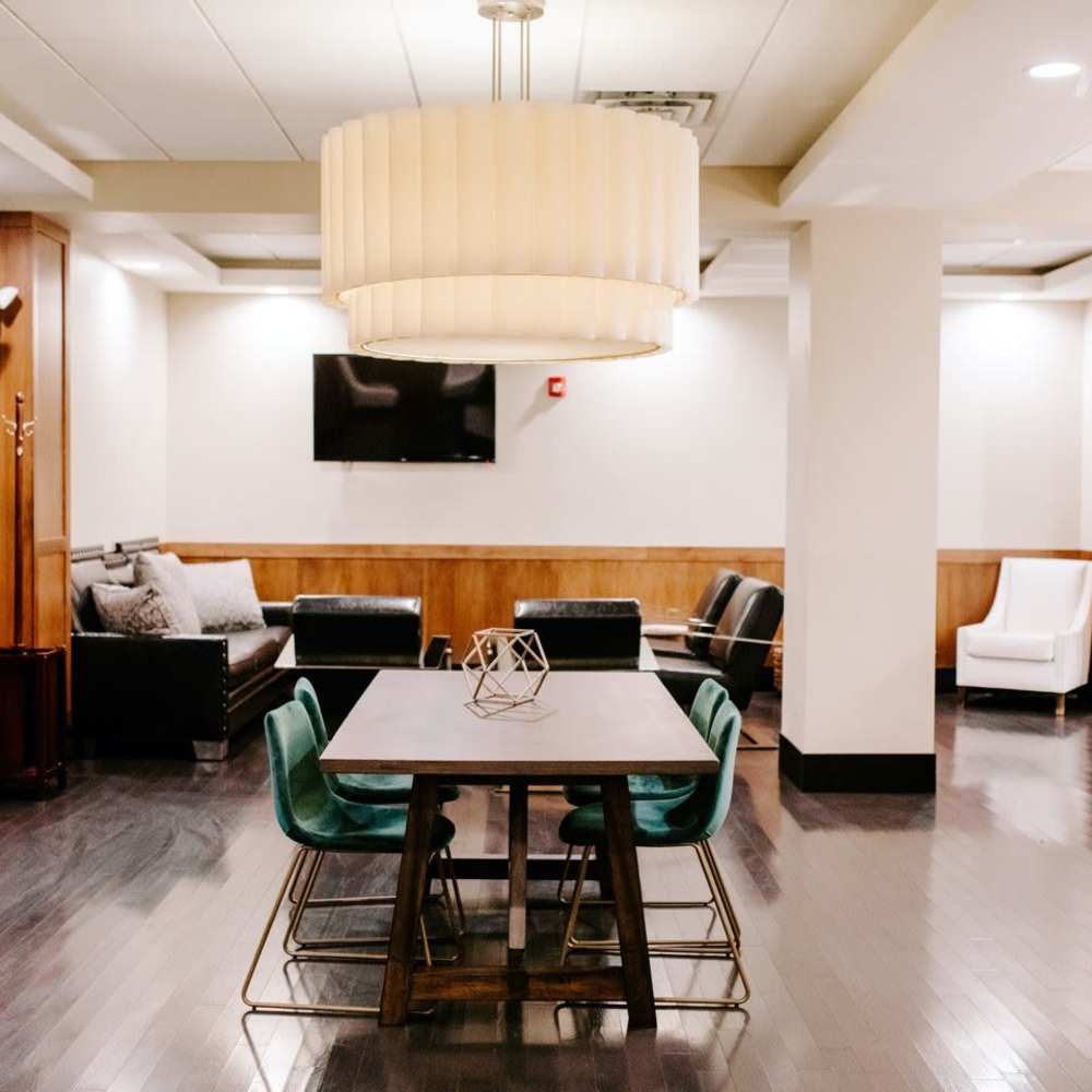 Cluhbhouse with dining table and lounge seating for community at 430 Oak Grove in Minneapolis, Minnesota