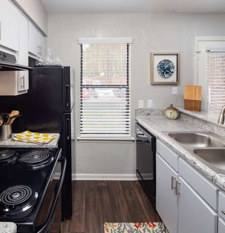 Galley kitchen with all major appliances at Sailboat Bay in Raleigh, North Carolina