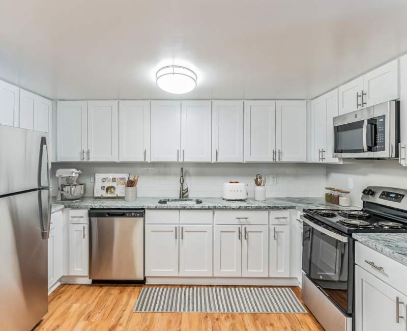 Model apartment kitchen with wood style flooring at Eagle Rock Apartments at Swampscott in Swampscott, Massachusetts