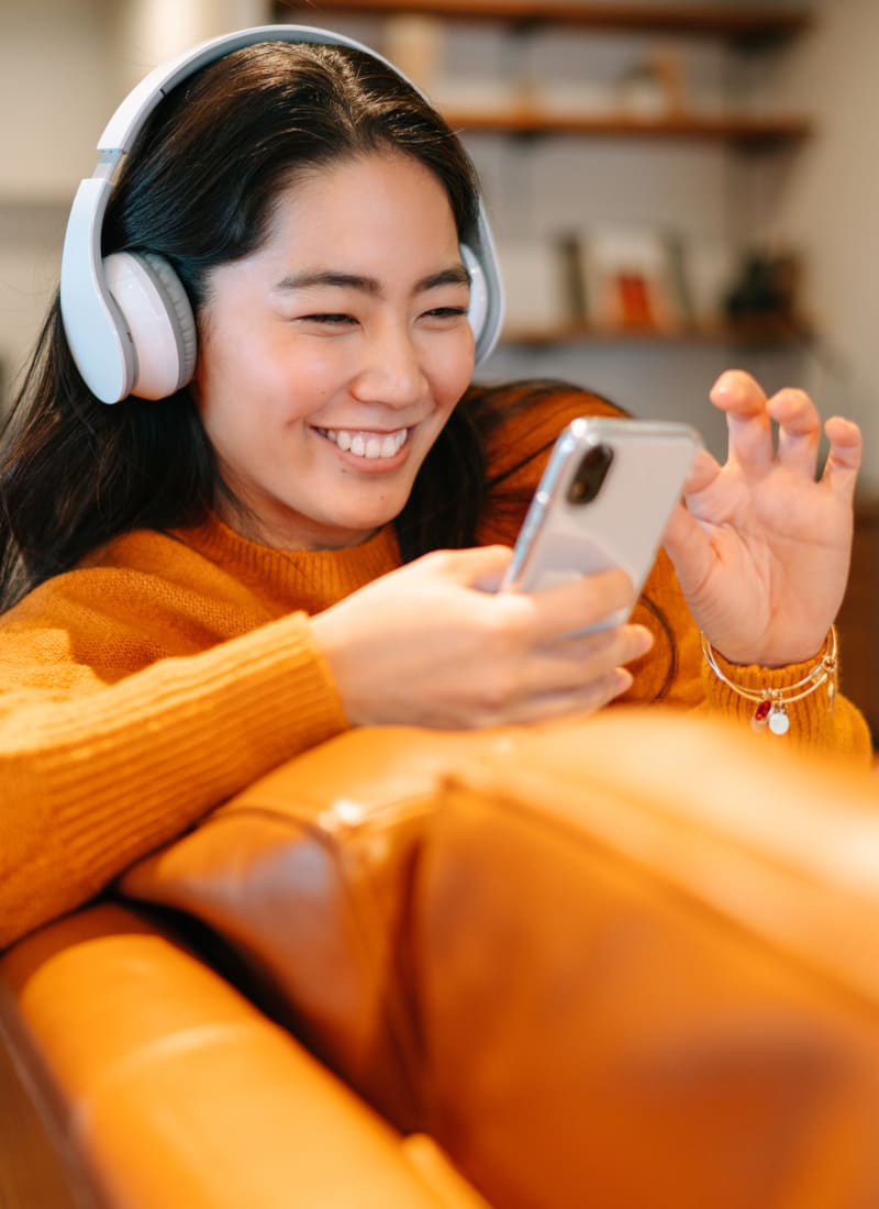 Resident listening to music on their couch at The Preserve at Ballantyne Commons in Charlotte, North Carolina