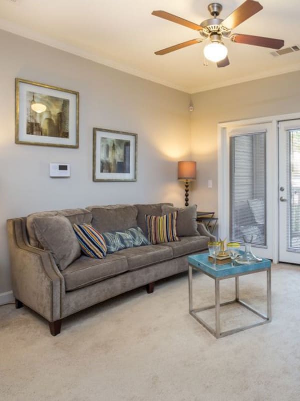 Cozy living room with balcony access and ceiling fan at 29 North in Hickory, North Carolina