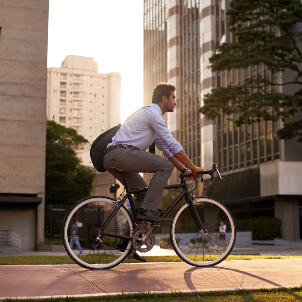 Resident biking to work at his downtown office near Oaks 5th Street Crossing at City Station in Garland, Texas