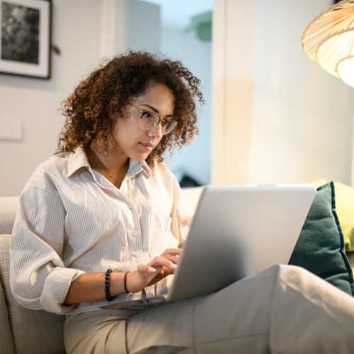 Resident working on a laptop at Stadium Loft Apartments in Saint Louis, Missouri