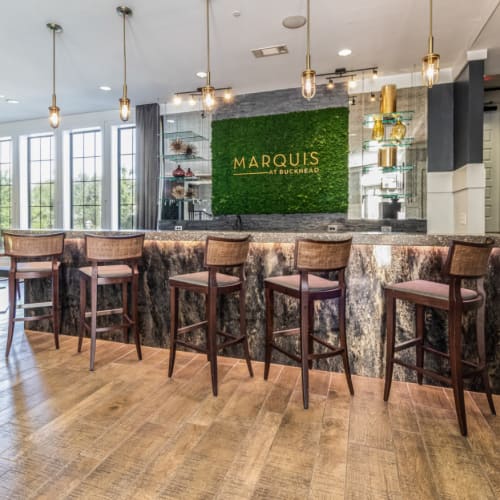 Indoor community room with counter seating and tall counter chairs at Marquis at Buckhead in Atlanta, Georgia
