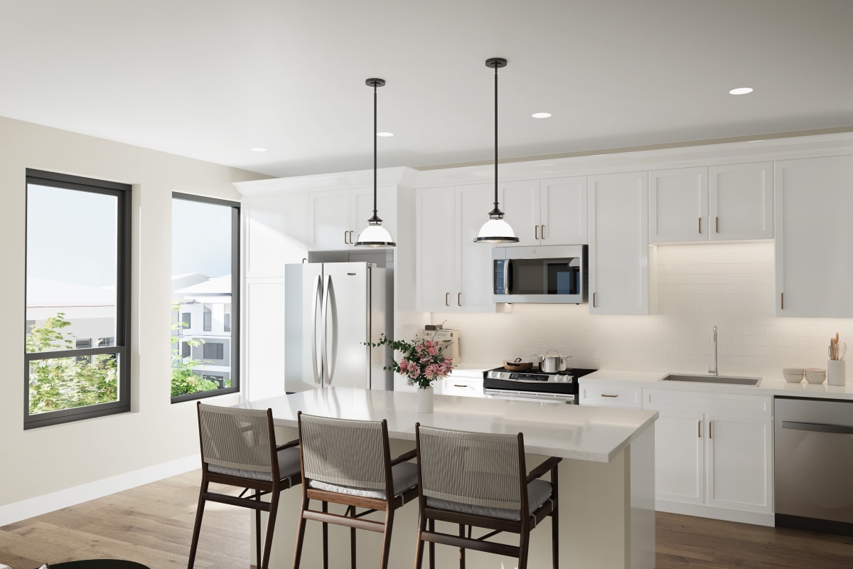 Modern kitchen with an island and stainless-steel appliances in a senior apartment's kitchen at Amira Lowry in Denver, Colorado