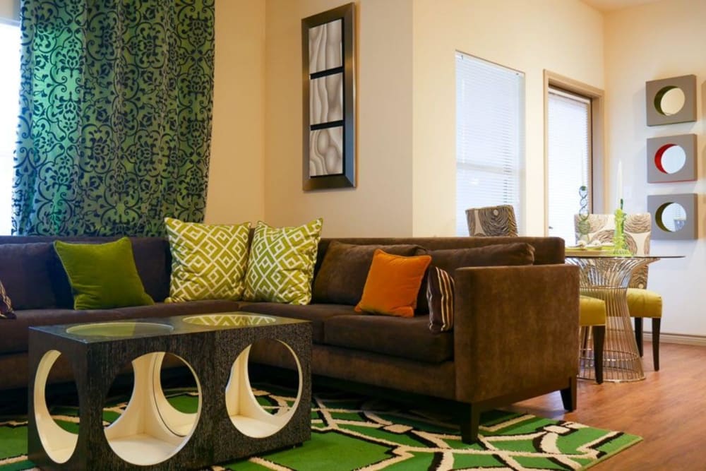 Model living room with hardwood style flooring at The BLVD in San Angelo, Texas