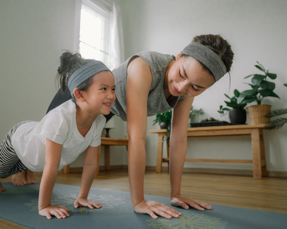 Resident doing yoga with her daughter at Greenfield Village in Rocky Hill, Connecticut