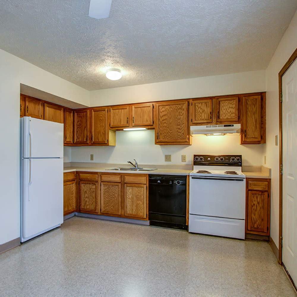 White refrigerator with wooden cabinets at Wellington Place in Ottawa, Ohio