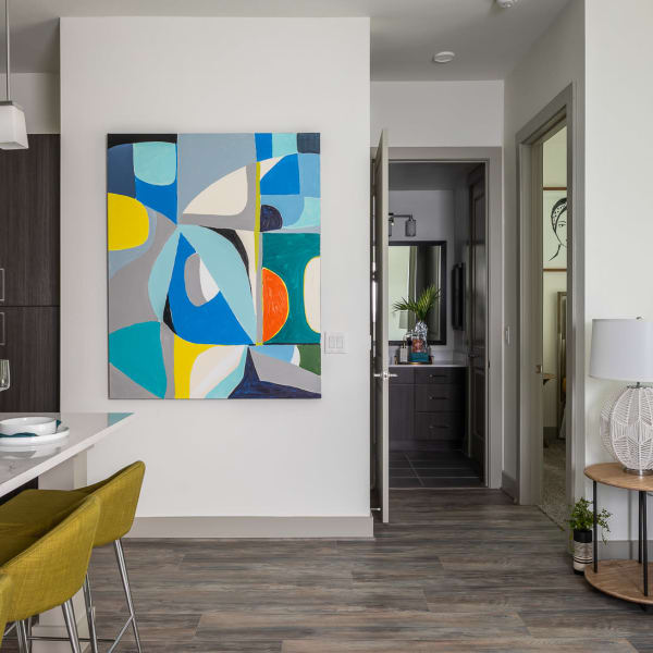 Modern apartment with hardwood floors and hanging art at Bellrock Summer Street in Houston, Texas